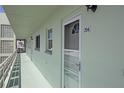 Exterior of a unit showcases a well-maintained entrance and serene walkway at 5935 30Th S Ave # 204, Gulfport, FL 33707