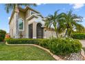 Inviting home features a screened entry, well-manicured lawn, and lovely landscaping details at 6239 French Creek Ct, Ellenton, FL 34222