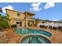 Backyard oasis with sparkling pool, hot tub, outdoor kitchen, and covered patio; perfect for entertaining at 6239 French Creek Ct, Ellenton, FL 34222