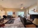 Open concept living room with sliding glass doors leading to outdoor area and adjacent dining space at 7123 Colonial Lake Dr, Riverview, FL 33578