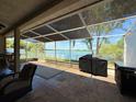 Spacious screened patio offering serene lake views, perfect for outdoor relaxation and entertainment at 7123 Colonial Lake Dr, Riverview, FL 33578