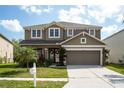 Charming two-story home with manicured lawn, two-car garage, and inviting curb appeal at 7653 Stoney Hill Dr, Wesley Chapel, FL 33545