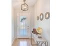 Welcoming foyer with decorative glass front door, light fixture, and stylish decorative accents at 9426 Green Needle Dr, New Port Richey, FL 34655