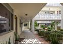 Exterior hallway with a white railing, plants, and multiple doors at 1012 Pearce Dr # 105, Clearwater, FL 33764