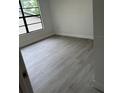Cozy bedroom with modern gray flooring and a large window for natural light at 10216 N Pawnee Ave, Tampa, FL 33617