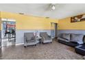 Comfortable living room featuring gray sofa, plush chairs and modern decor at 1407 Overlea St, Clearwater, FL 33755