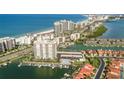 Scenic aerial view of the condo building, marina, and coastline at 1621 Gulf Blvd # 308, Clearwater Beach, FL 33767