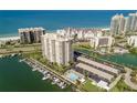 An aerial view of the condo building, its amenities, the marina and beach at 1621 Gulf Blvd # 308, Clearwater Beach, FL 33767