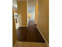 Hallway leading to kitchen featuring hard surface floors and neutral paint scheme at 18575 Bridle Club Dr # 18575, Tampa, FL 33647