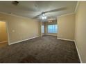Neutral living room with large window for natural light and ceiling fan at 18575 Bridle Club Dr # 18575, Tampa, FL 33647