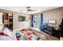 Cozy bedroom with a closet, a ceiling fan, and access to the outdoor pool via sliding glass door at 1947 Citrus Hill Ln, Palm Harbor, FL 34683