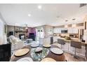 Inviting open-concept living space with a fireplace, modern kitchen, and dining area for seamless entertaining at 1947 Citrus Hill Ln, Palm Harbor, FL 34683