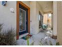 Leaded glass front door with a covered front porch and cozy seating area with a hello mat at 20220 Autumn Fern Ave, Tampa, FL 33647