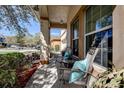 Cozy front porch features comfortable seating, perfect for relaxing and enjoying the neighborhood view at 20220 Autumn Fern Ave, Tampa, FL 33647
