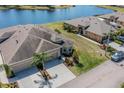 Gorgeous home with lake view, mature landscaping, and convenient driveway access at 2234 Nottingham Greens Dr # 2234, Sun City Center, FL 33573