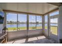 Relaxing sun room with tiled floors and panoramic views of the serene lake at 2234 Nottingham Greens Dr # 2234, Sun City Center, FL 33573