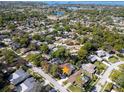 An aerial view shows the neighborhood, mature trees, and proximity to the water at 2462 Indian E Trl, Palm Harbor, FL 34683