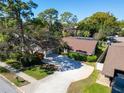 Well-maintained home boasts mature landscaping, a long driveway, and a screened-in pool at 2462 Indian E Trl, Palm Harbor, FL 34683
