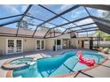 A beautiful screened-in pool features a hot tub, perfect for relaxing and entertaining at 2462 Indian E Trl, Palm Harbor, FL 34683
