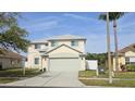 Two-story home with a two-car garage, well-maintained lawn, and classic curb appeal at 25631 Bruford Blvd, Land O Lakes, FL 34639