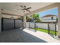 Covered patio with gray tile flooring, ceiling fan, and view of the fenced backyard at 2608 W Saint Joseph St # 2, Tampa, FL 33607