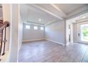 Bright living room featuring tray ceiling, wood-look tile flooring, and an abundance of natural light at 2671 Murray Pass, Odessa, FL 33556