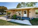 Inviting front porch with landscaping, decorative details, and a well-maintained yard at 2707 Morningside Dr, Clearwater, FL 33759