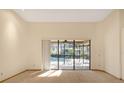 Bright living room featuring large glass doors offering a view of the pool and access to the outdoor area at 2806 Forest Club Dr, Plant City, FL 33566