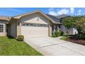 Inviting single-Gathering home with a well-maintained lawn, a two-car garage, and a charming front yard with mature landscaping at 2991 Covewood Pl, Clearwater, FL 33761