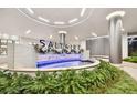 Close-up of the 'SALTAIRE' water feature with modern design and lush greenery at 301 1St S St # 1206, St Petersburg, FL 33701