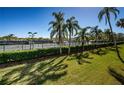 Well-maintained tennis courts surrounded by lush greenery and palm trees on a clear day at 3021 Countryside Blvd # 26A, Clearwater, FL 33761