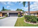 Well-kept home featuring a spacious driveway and an attached two-car garage at 3212 Mcmath Dr, Palm Harbor, FL 34684
