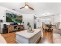 Spacious living room with an entertainment area, barn door accent, and a dining space with modern lighting at 35128 Excalibur Rd, Webster, FL 33597