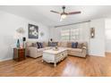 Cozy living room with a comfortable sectional sofa, wood-look flooring, and a ceiling fan for added comfort at 35128 Excalibur Rd, Webster, FL 33597