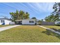 Charming single-story home with a well-manicured lawn and quaint carport under a clear blue sky at 4030 Marlin Se Dr, St Petersburg, FL 33705