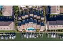 Aerial view of waterfront townhomes and boat docks with community pool in the center at 487 Pinellas Bayway S # 6, Tierra Verde, FL 33715