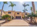 Townhome with two-car garage and paver driveway with mature palms at 487 Pinellas Bayway S # 6, Tierra Verde, FL 33715