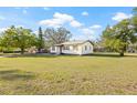 Cozy single-level home with a well-kept lawn and classic shutters, offering a welcoming curb appeal at 501 W Bird St, Tampa, FL 33604