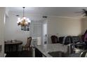 Open living area with a view of the dining area, modern lighting fixture, and comfortable seating at 5606 Pinnacle Heights Cir # 105, Tampa, FL 33624