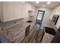 Bright kitchen features stainless steel appliances, white cabinets and beautiful granite countertops at 5725 80Th N St # 314, St Petersburg, FL 33709
