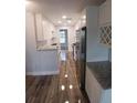 Bright kitchen featuring white cabinets, stainless steel appliances, and granite countertops at 5725 80Th N St # 314, St Petersburg, FL 33709