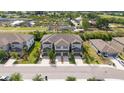 Wide aerial view showing the neighborhood and landscaping of the townhouses at 607 Royal Empress Dr, Ruskin, FL 33570
