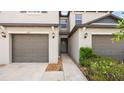 Neutral-colored two-story townhouse with a private garage and inviting entrance at 607 Royal Empress Dr, Ruskin, FL 33570