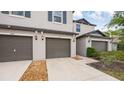 Two-story townhouse with driveway and a brown garage door at 607 Royal Empress Dr, Ruskin, FL 33570