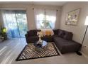 Cozy living room with a plush sectional sofa, patterned rug, and sliding glass doors at 607 Royal Empress Dr, Ruskin, FL 33570