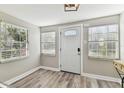 Bright entryway features wood-look flooring, windows, and a white front door at 6316 S Richard Ave, Tampa, FL 33616