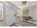 Inviting entryway showcases wood-look flooring, bike decor and a bright window at 6316 S Richard Ave, Tampa, FL 33616