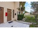 Exterior view of townhome with lawn, tidy landscaping, and a neutral-colored exterior at 6475 23Rd N St, St Petersburg, FL 33702