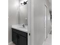 Well-lit half bathroom featuring modern fixtures and a sleek vanity at 6709 Lake Rochester Ln, Gibsonton, FL 33534