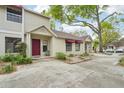 A row of tan townhomes featuring red awnings and neatly kept landscaping at 8419 Laurelon Pl, Temple Terrace, FL 33637